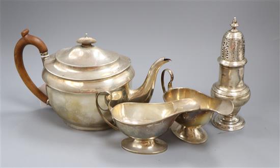 A pair of Edwardian silver sauce boats, a silver sugar caster and a silver teapot, gross 36 oz.